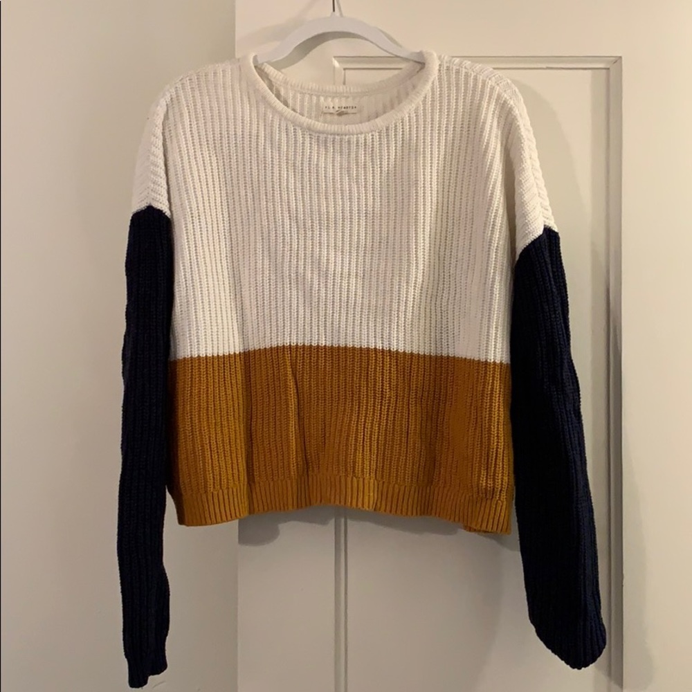 White, gold, and navy crew neck sweater.